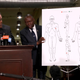 Attorney Ben Crump holds a diagram showing gunshot wounds to Stephon Clark during a news conference at the Southside Christian Center on March 30, 2018, in Sacramento, Calif.